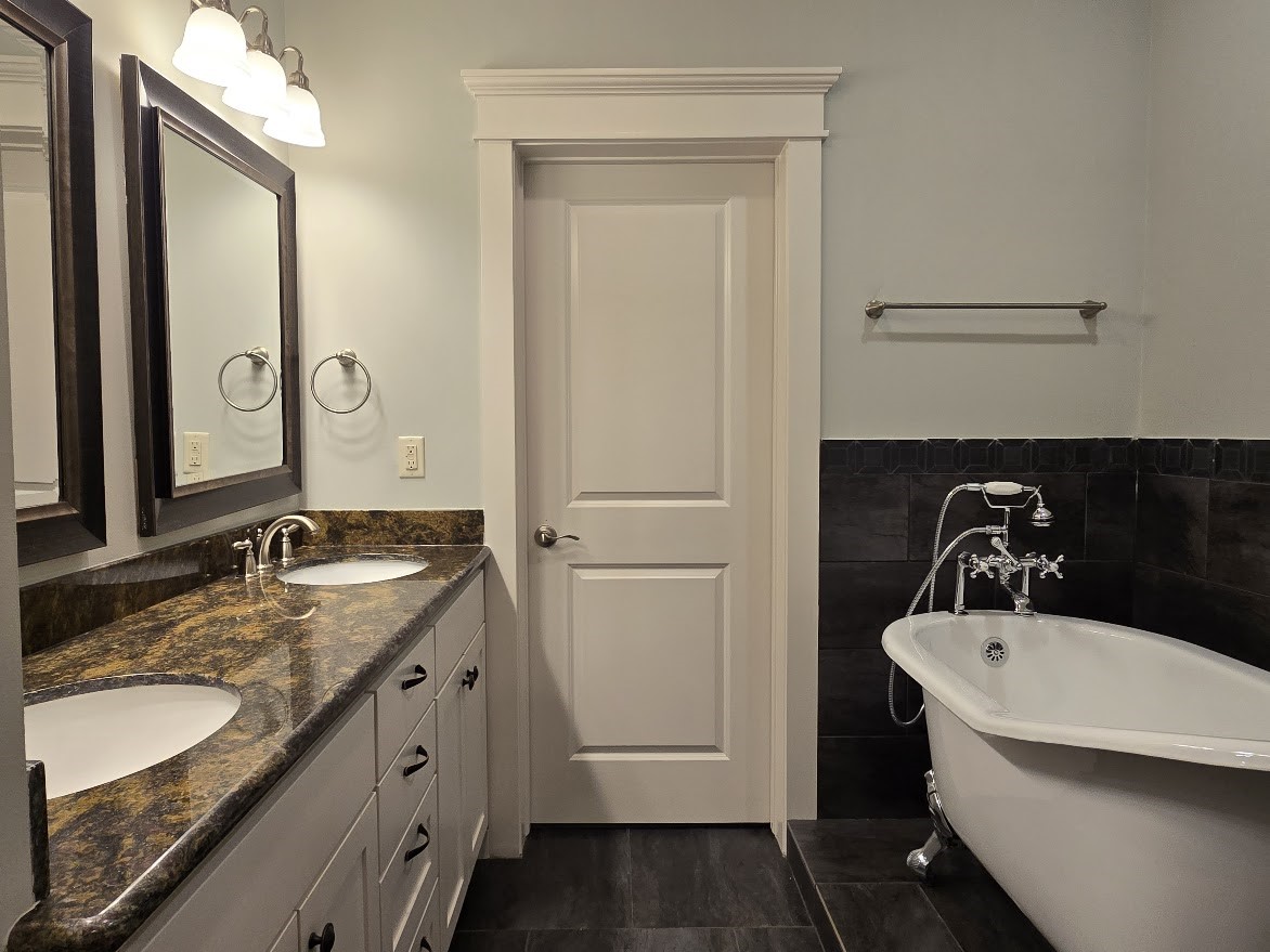4109 Allen Street Houston, TX 77007 - Photo 32 of 42 Primary bathroom features double sinks, granite countertops, soft-close drawers & cabinets and a claw foot luxury stand alone soaking tub. Door to primary walk-in closet.
