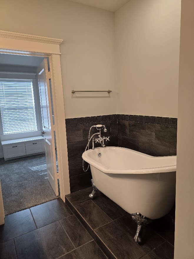 4109 Allen Street Houston, TX 77007 - Photo 35 of 42 Standalone claw foot luxury soaking tub sits on a raised platform, adding character and dimension to the space. Primary closet pictured to left.
