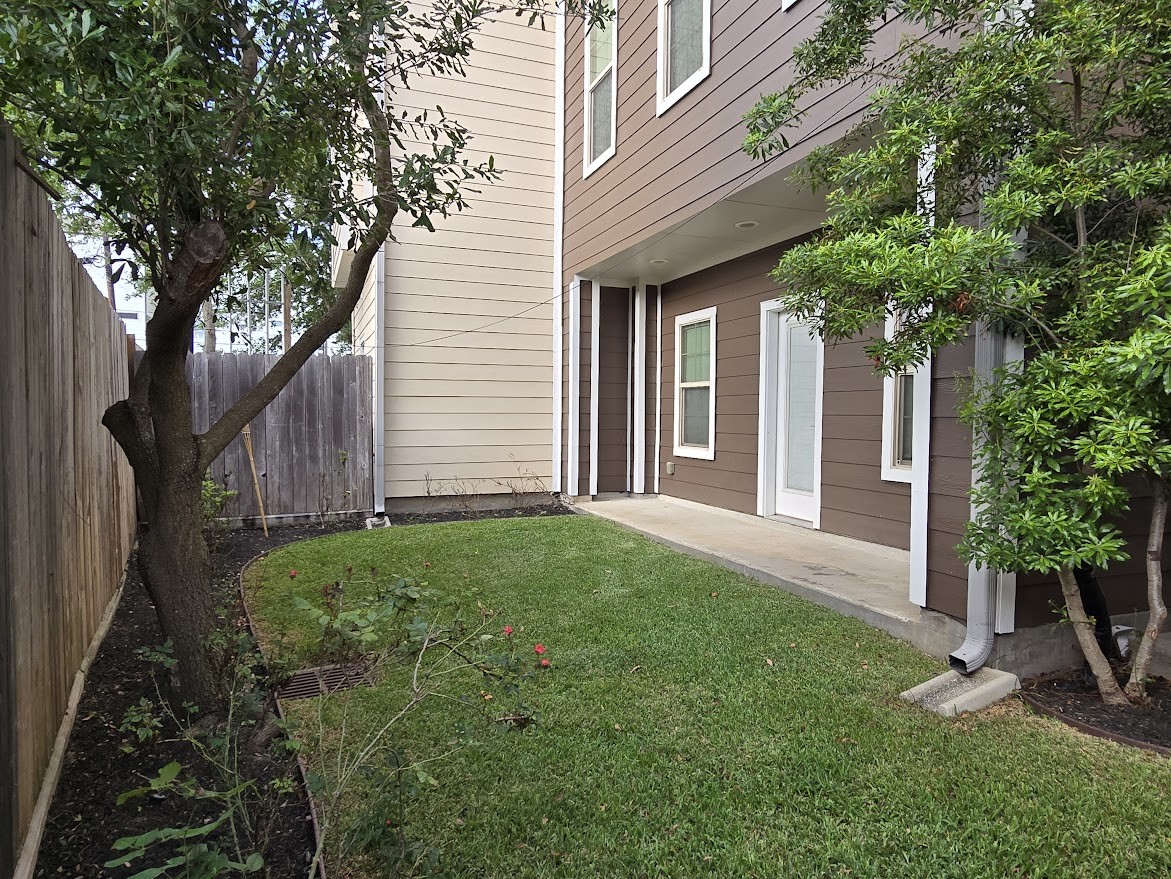 4109 Allen Street Houston, TX 77007 - Photo 39 of 42 Backyard view of the 1st floor bedroom's patio area. Lush green space and flowerbeds ready for springtime gardening.