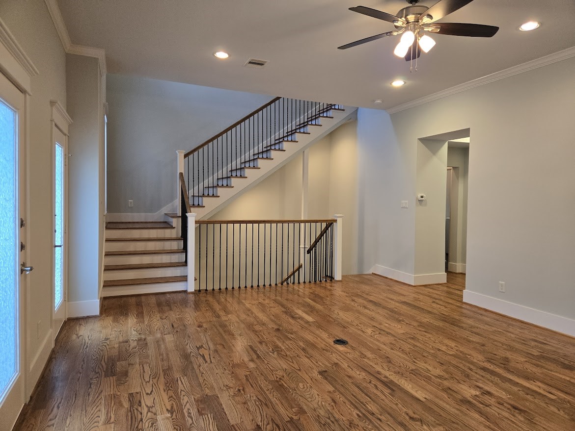 4109 Allen Street Houston, TX 77007 - Photo 10 of 42 Living room showcasing the beautiful hardwood floors. Stairs leading to both the 1st and 3rd floors.
