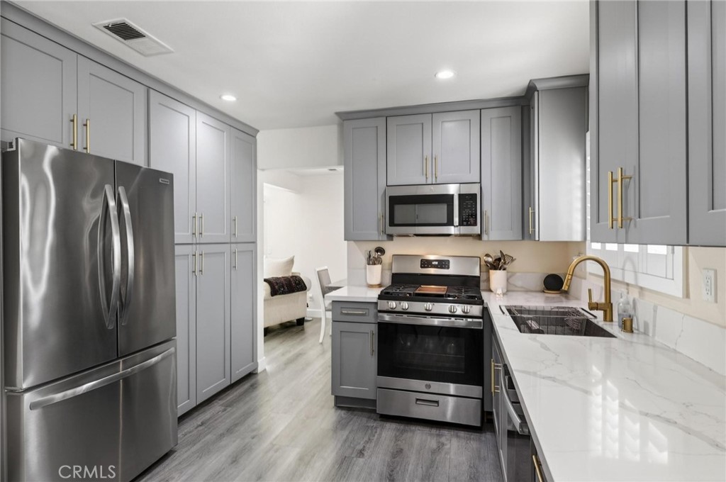 910 East Meadbrook Street Carson, CA 90746 - Photo 13 of 39 a kitchen with a refrigerator stove and sink