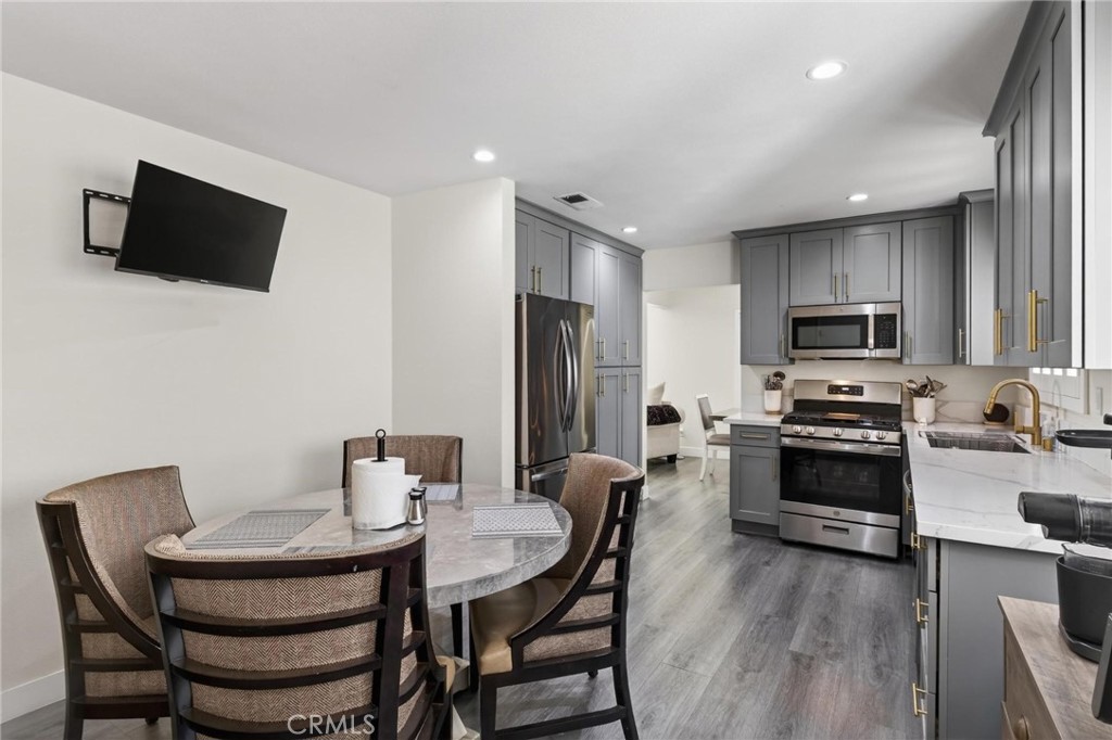 910 East Meadbrook Street Carson, CA 90746 - Photo 15 of 39 a kitchen with a table chairs microwave and refrigerator