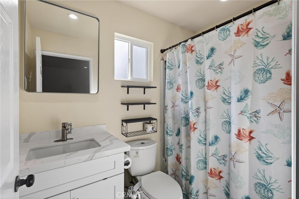 910 East Meadbrook Street Carson, CA 90746 - Photo 29 of 39 a bathroom with a toilet sink vanity and mirror