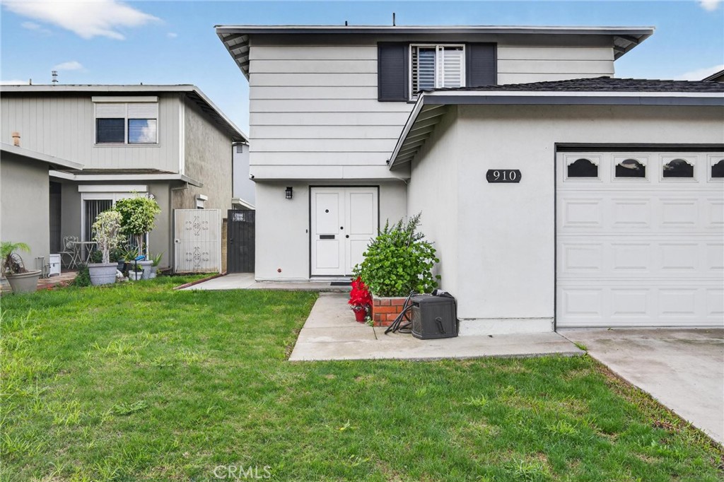 910 East Meadbrook Street Carson, CA 90746 - Photo 3 of 39 a front view of a house with a yard