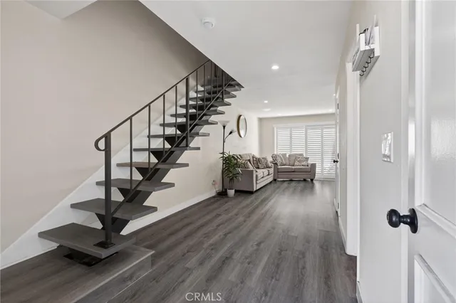 a view of a hallway with wooden floor and front door