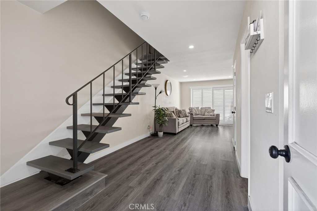 910 East Meadbrook Street Carson, CA 90746 - Photo 5 of 39 a view of a hallway with wooden floor and front door