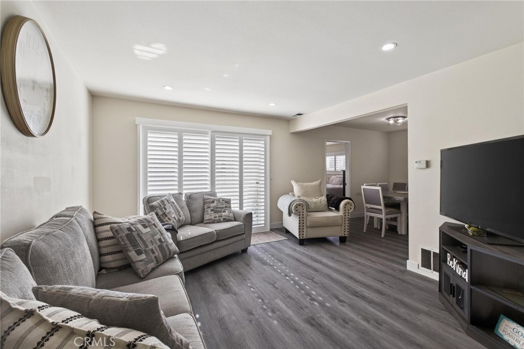 910 East Meadbrook Street Carson, CA 90746 - Photo 9 of 39 a living room with furniture a window and a flat screen tv
