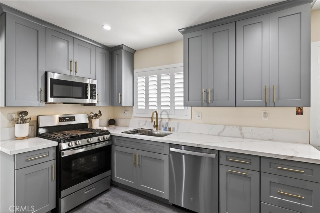 910 East Meadbrook Street Carson, CA 90746 - Photo 10 of 39 a kitchen with granite countertop a sink stainless steel appliances and cabinets