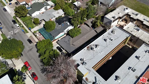 an aerial view of multiple houses with yard