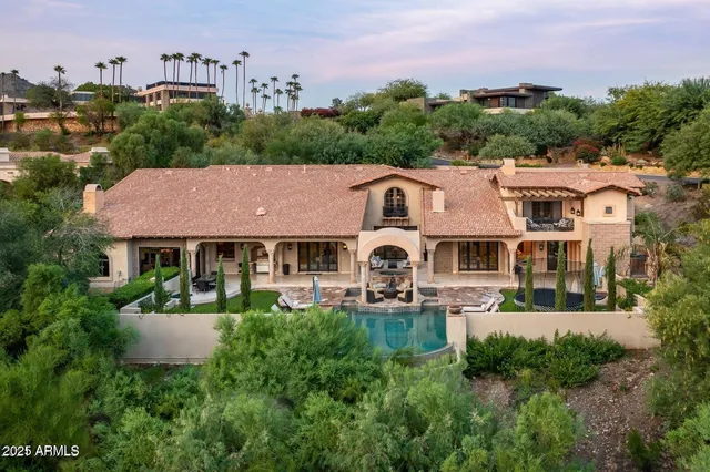 an aerial view of a house with garden space and a street view