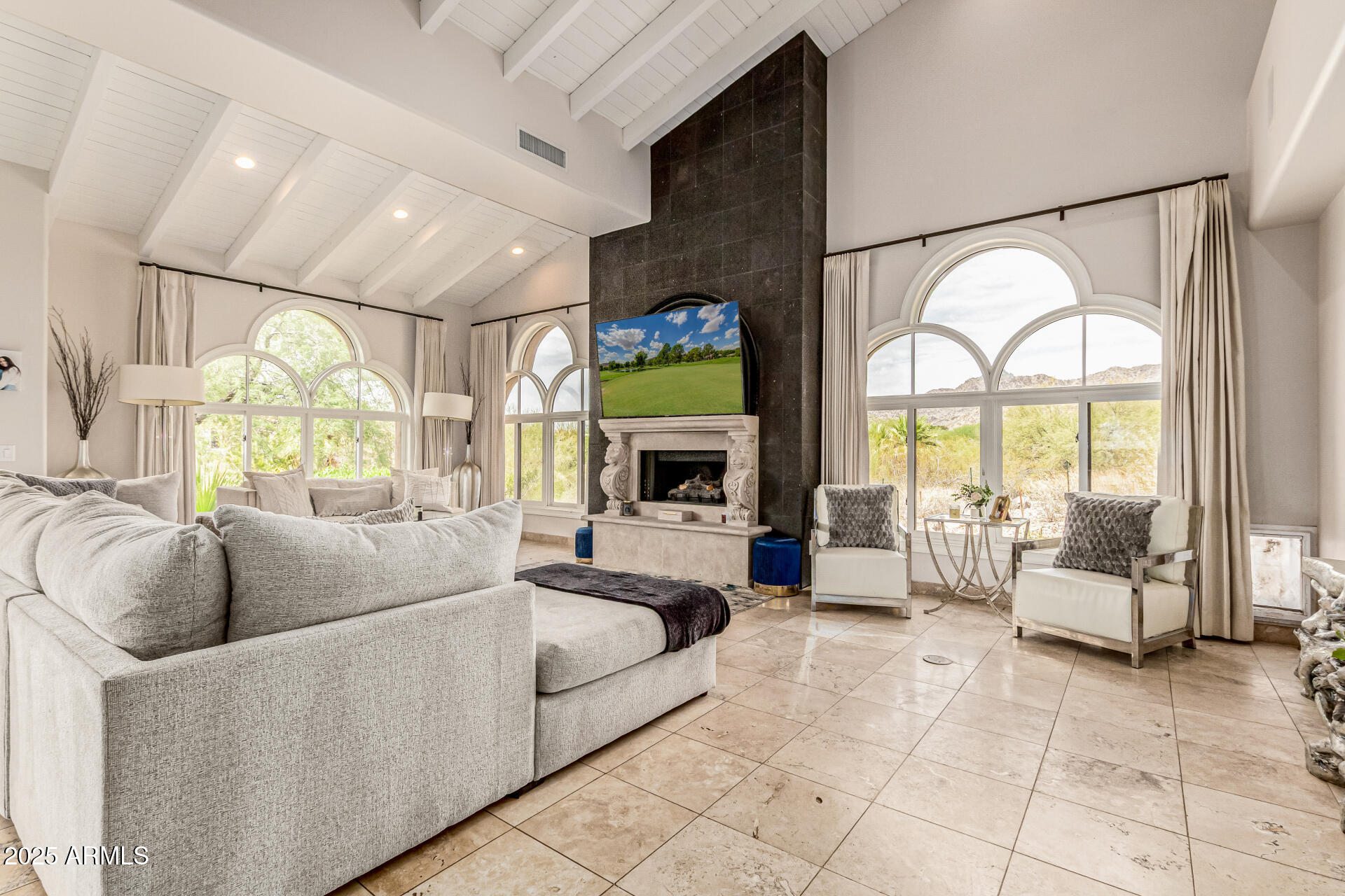 6050 North Paradise View Drive Paradise Valley, AZ 85253 - Photo 12 of 79 a living room with furniture a fireplace and a flat screen tv