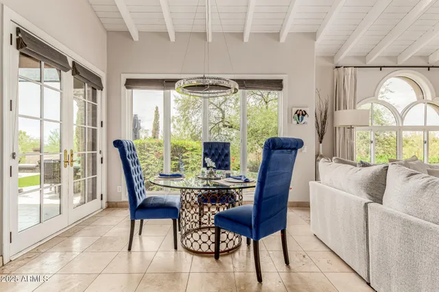 a kitchen with stainless steel appliances granite countertop a stove a sink and white cabinets next to a window
