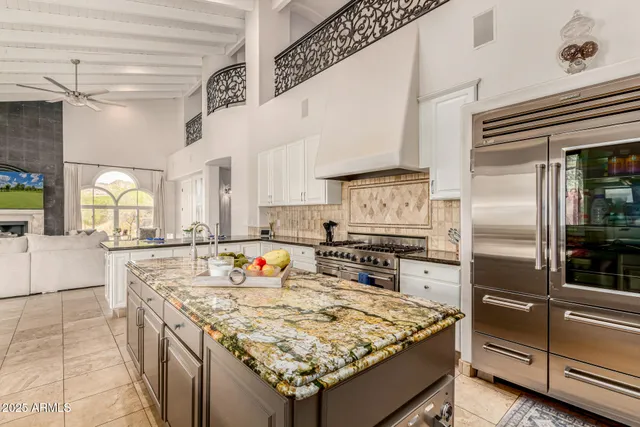 a living room with furniture a large window and a fireplace
