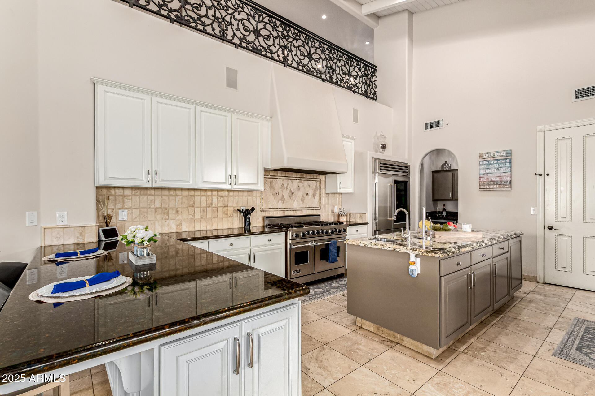 6050 North Paradise View Drive Paradise Valley, AZ 85253 - Photo 19 of 79 a kitchen with stainless steel appliances granite countertop a stove sink and cabinets