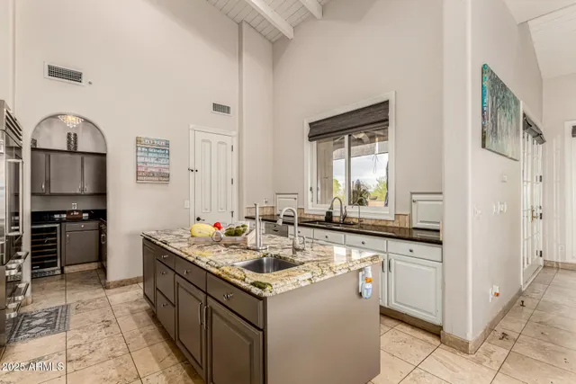 a bedroom with a large bed and a chandelier