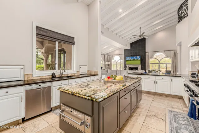 a living room with furniture and a floor to ceiling window