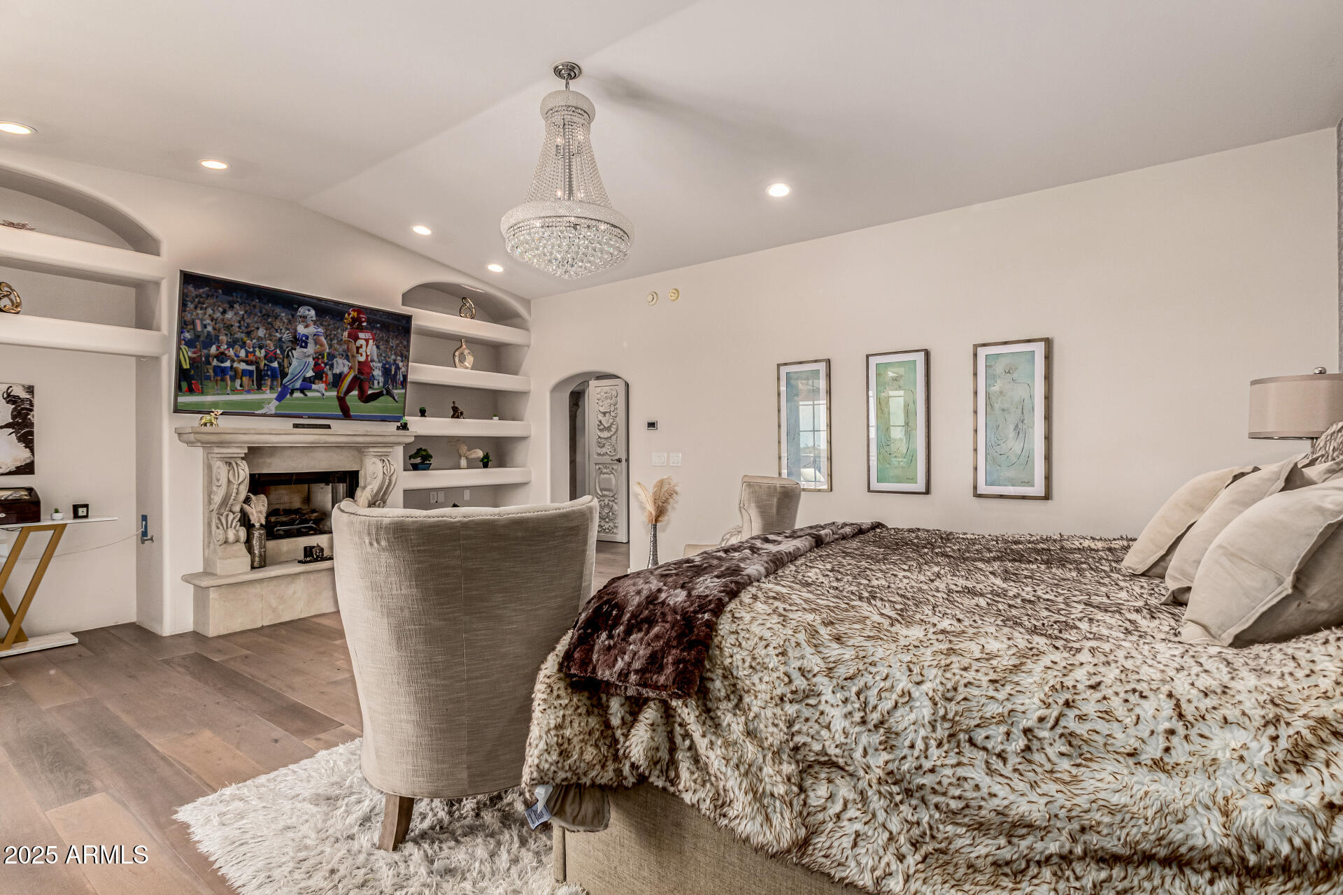 6050 North Paradise View Drive Paradise Valley, AZ 85253 - Photo 28 of 79 a bedroom with a large bed and a chandelier