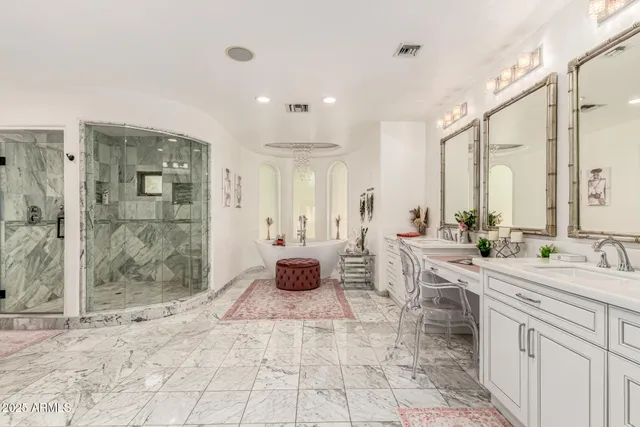 a bathroom with a glass shower door and a bathtub