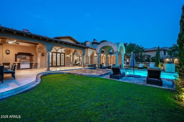 a dining room with stainless steel appliances kitchen island granite countertop a dining table and chairs with wooden floor