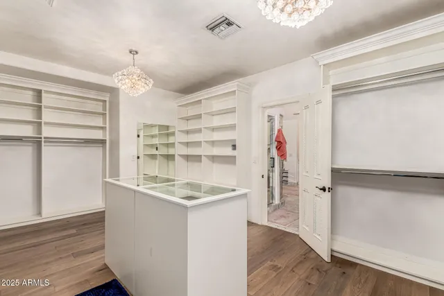 a bedroom with furniture and a wooden floor