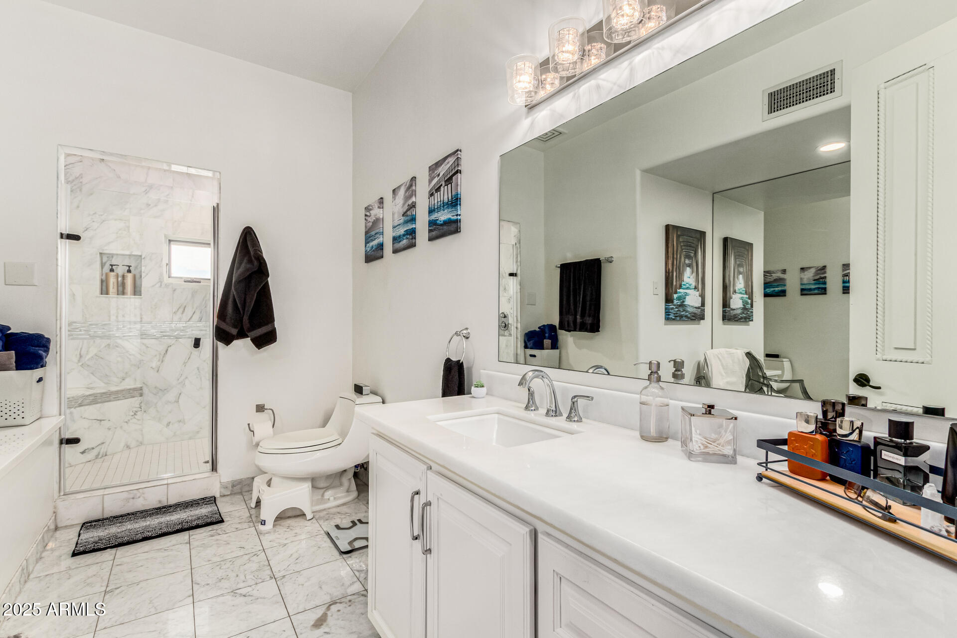 6050 North Paradise View Drive Paradise Valley, AZ 85253 - Photo 37 of 79 a bathroom with a toilet sink and mirror