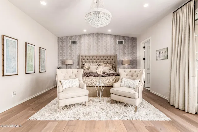 a front view of a house with a yard and potted plants