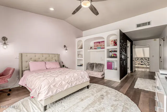 a living room with a couch and a computer on a desk