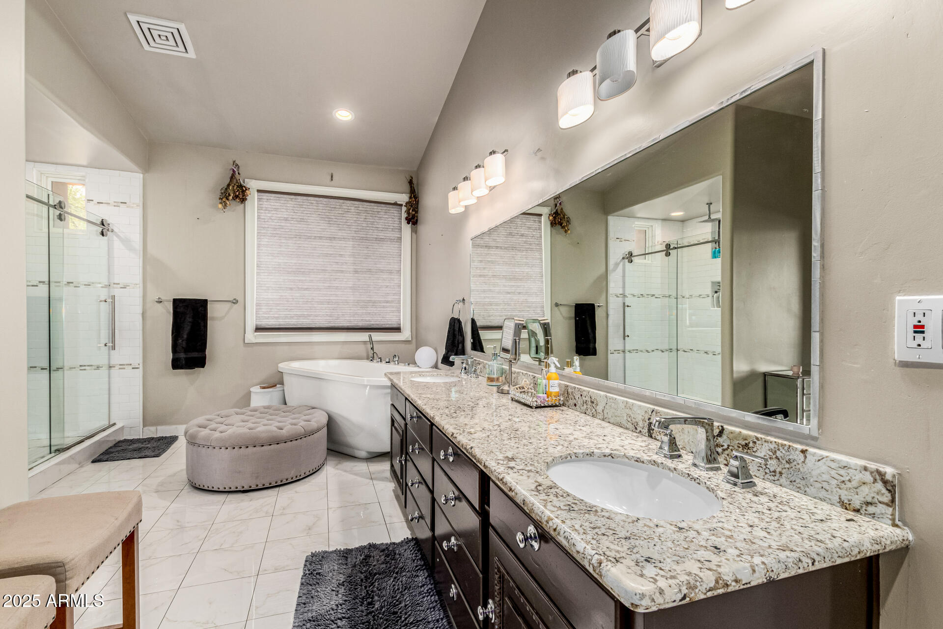 6050 North Paradise View Drive Paradise Valley, AZ 85253 - Photo 47 of 79 a spacious bathroom with a granite countertop sink a mirror and a shower