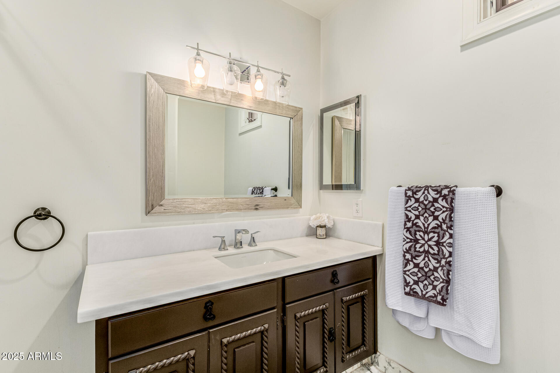 6050 North Paradise View Drive Paradise Valley, AZ 85253 - Photo 53 of 79 a bathroom with a sink and a mirror