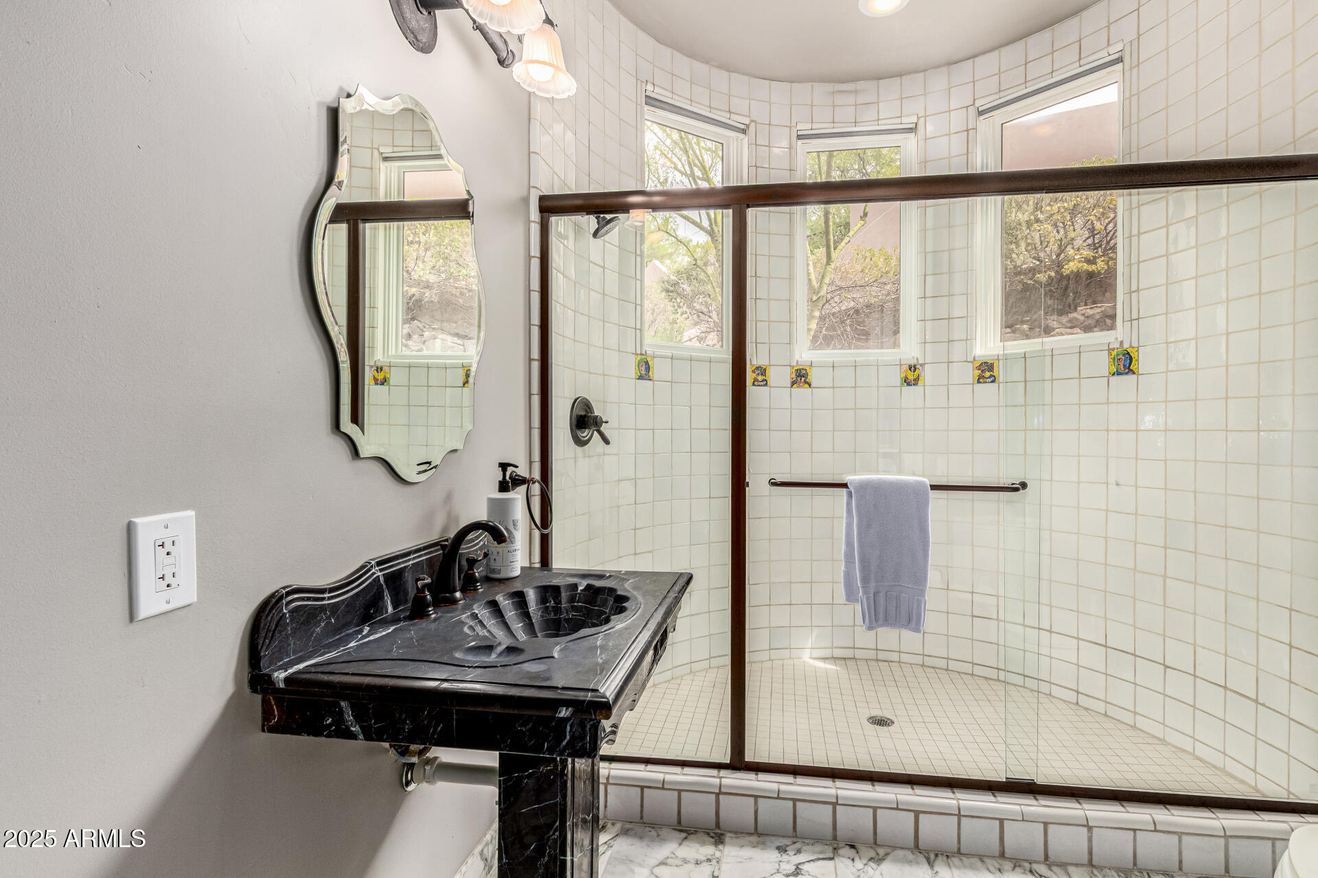 6050 North Paradise View Drive Paradise Valley, AZ 85253 - Photo 62 of 79 a bathroom with a sink a mirror and a shower