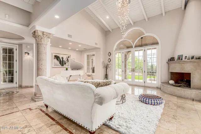 a living room with furniture and a chandelier