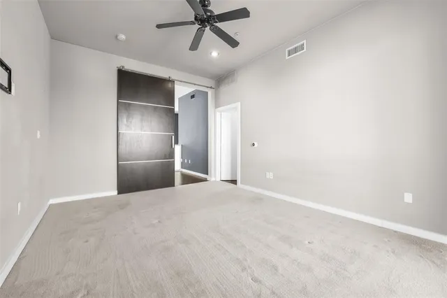 a view of an empty room with a ceiling fan