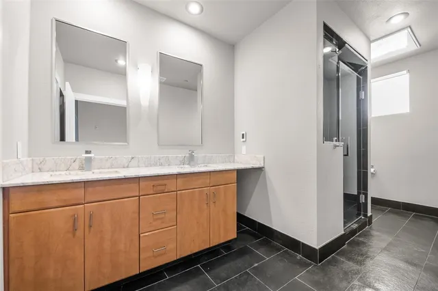 a bathroom with a double vanity sink and mirror