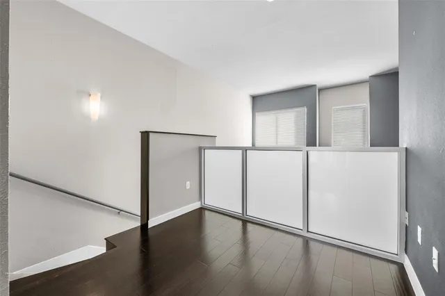 an empty room with wooden floor