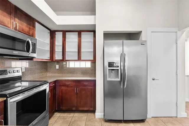 a kitchen with stainless steel appliances granite countertop a refrigerator and a stove