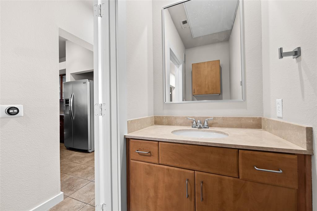 6927 Sumner Street, Unit 6927 The Colony, TX 75056 - Photo 9 of 22 a bathroom with a sink and a mirror