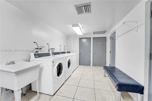 a kitchen with a sink a stove cabinets and a refrigerator
