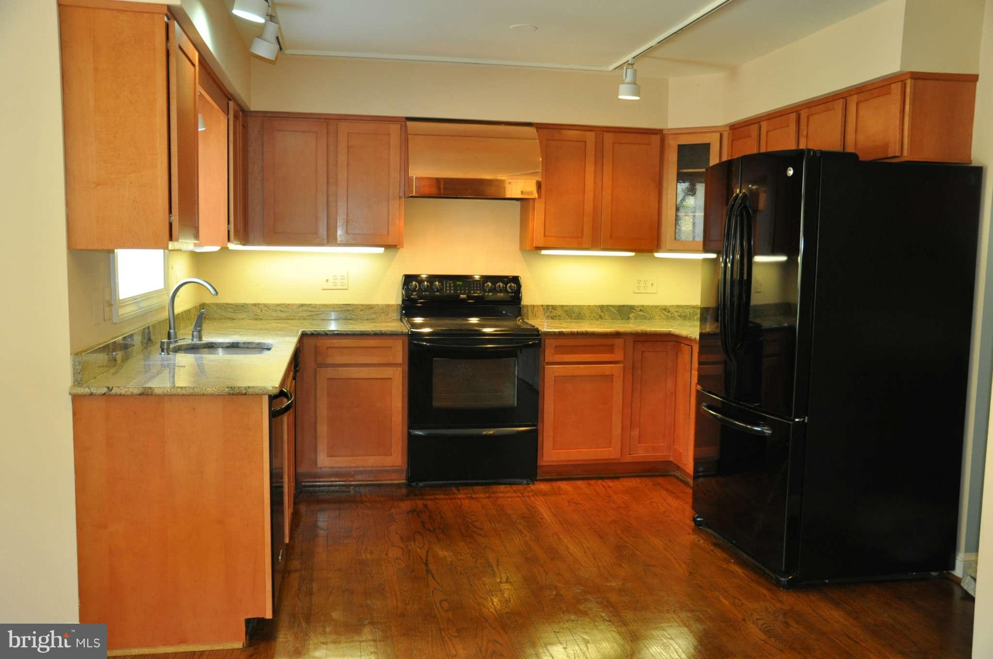 9220 Jones Mill Road Chevy Chase, MD 20815 - Photo 14 of 25 a kitchen with a refrigerator stove and sink
