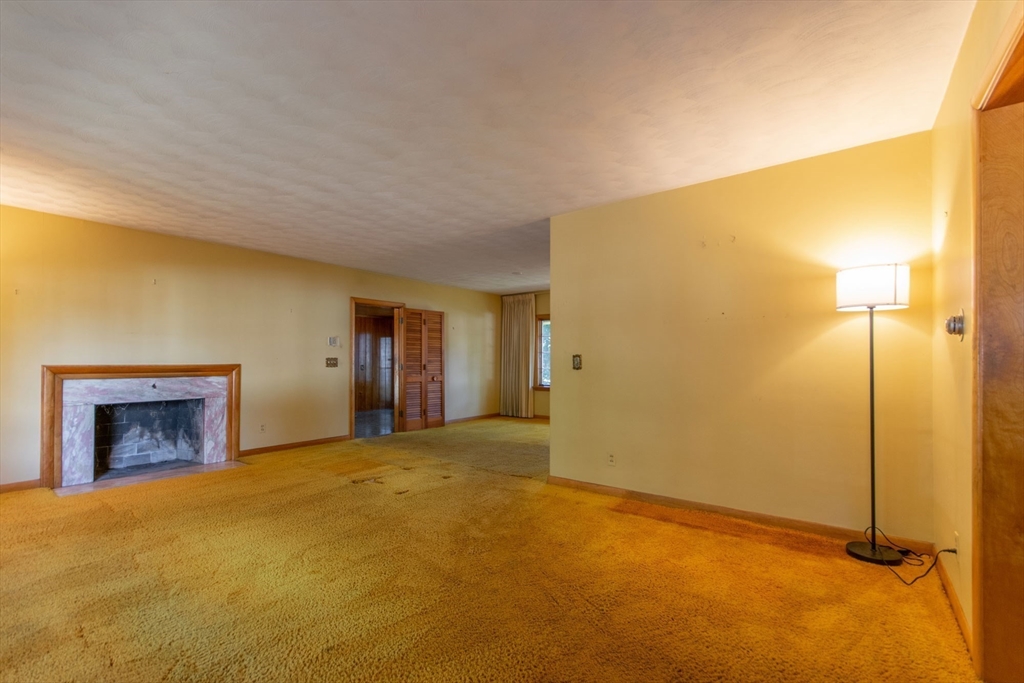182 Dayton Street Springfield, MA 01118 - Photo 14 of 30 a view of an empty room with a fireplace