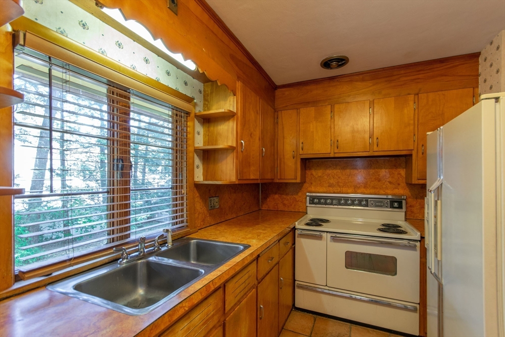 182 Dayton Street Springfield, MA 01118 - Photo 18 of 30 a kitchen with a stove a sink and a refrigerator