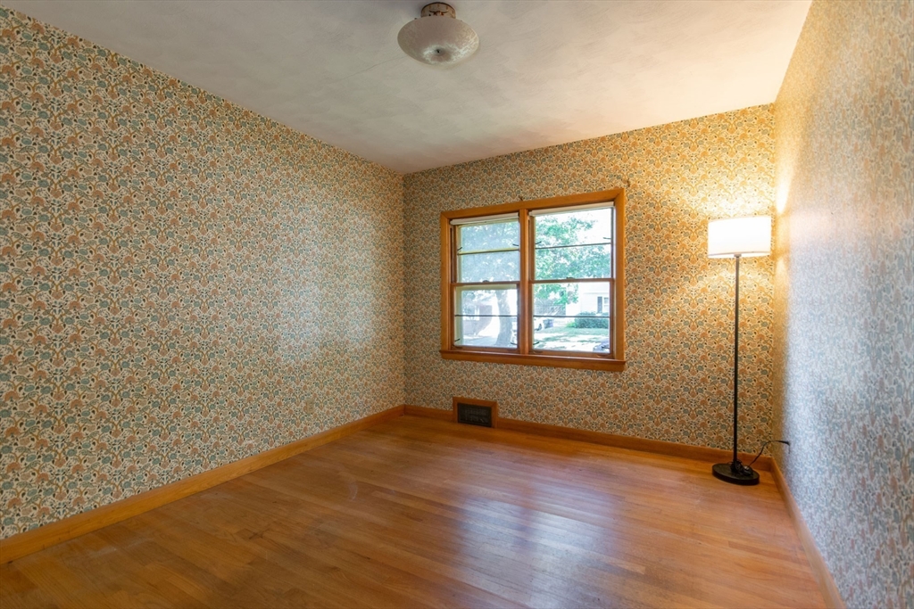 182 Dayton Street Springfield, MA 01118 - Photo 22 of 30 an empty room with wooden floor and windows