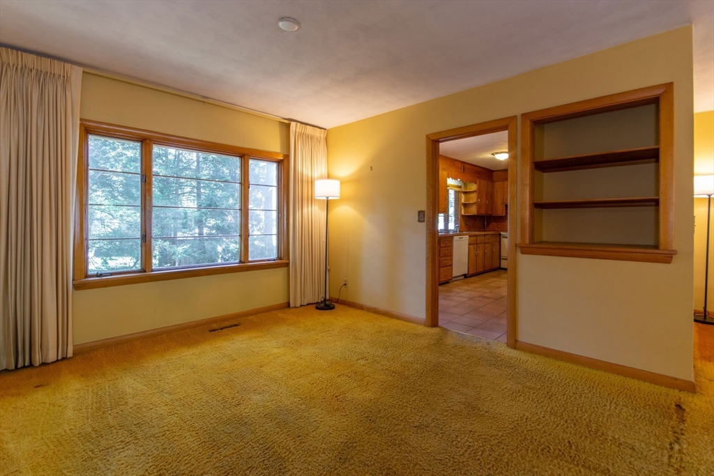 182 Dayton Street Springfield, MA 01118 - Photo 9 of 30 a view of an empty room with a window and a kitchen