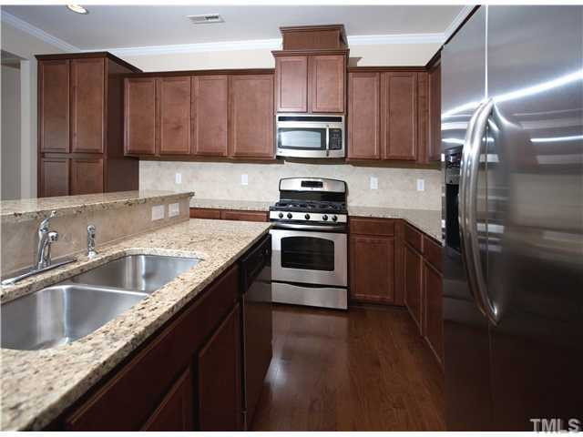 1124 Falcon Ridge Lane Morrisville, NC 27560 - Photo 3 of 3 a kitchen with a sink stove and cabinets