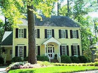 1504 Pineview Street Raleigh, NC 27608 - Photo 1 of 1 a view of a brick house with large windows and a yard