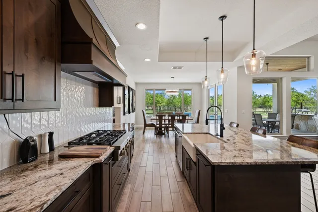 a kitchen with sink stove and cabinets