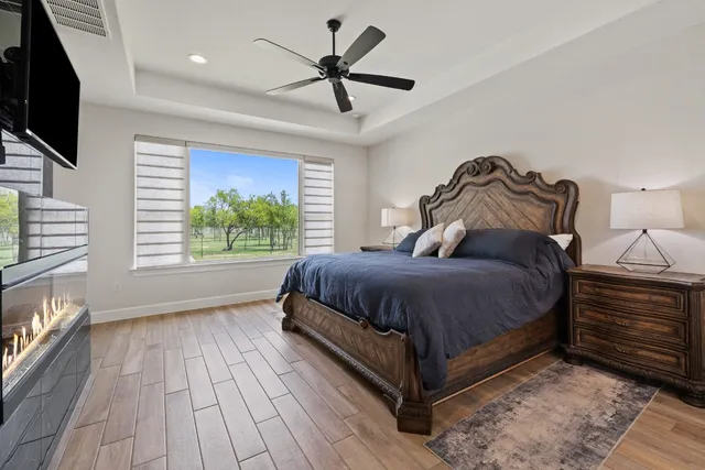 a bedroom with a bed and a television