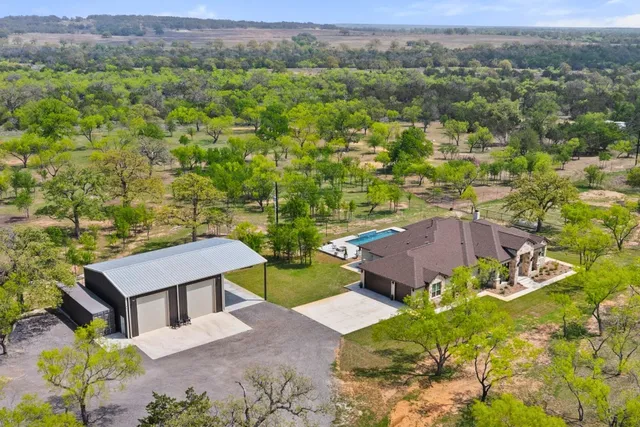 an aerial view of a house with a yard