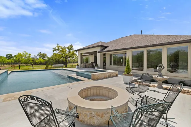 a view of a patio with swimming pool table and chairs