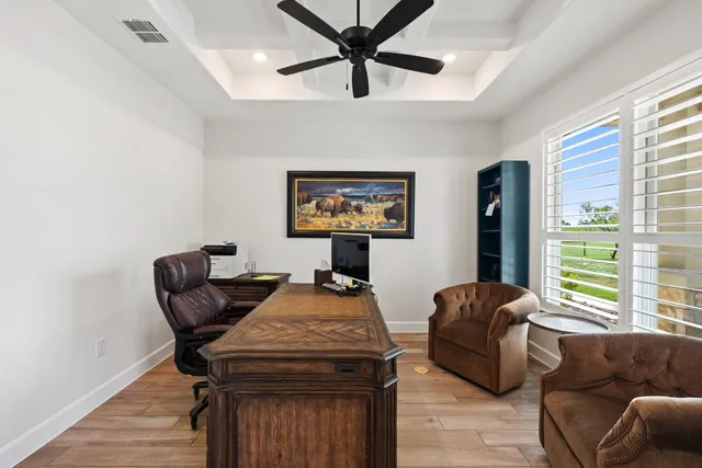 a living room with furniture a window and a chandelier