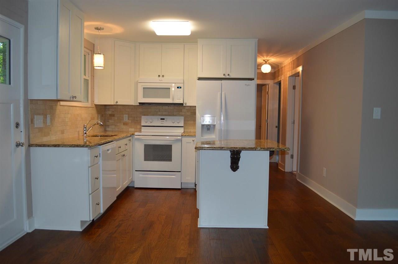 110 Nancy Rhodes Drive Durham, NC 27712 - Photo 12 of 24 a kitchen with a refrigerator a sink and cabinets